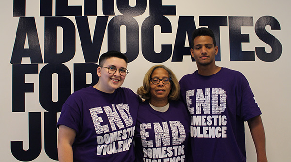 President Karol Mason with two John Jay students