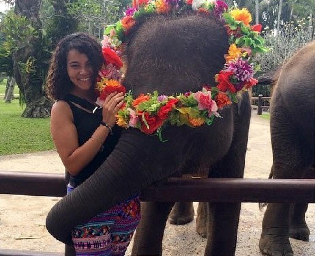 student in Bali posing with elephant