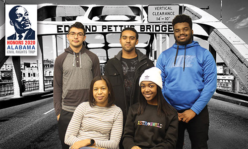 A group of John Jay Students posing in front of a backdrop of Edmund Pettus Bridge