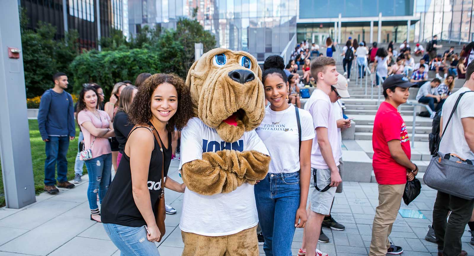 Students posing with John Jay's mascot the Bloodhound on Jaywalk