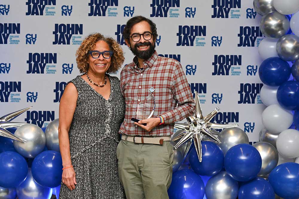 President Mason posing with award recipient at BRAVO 2025 event