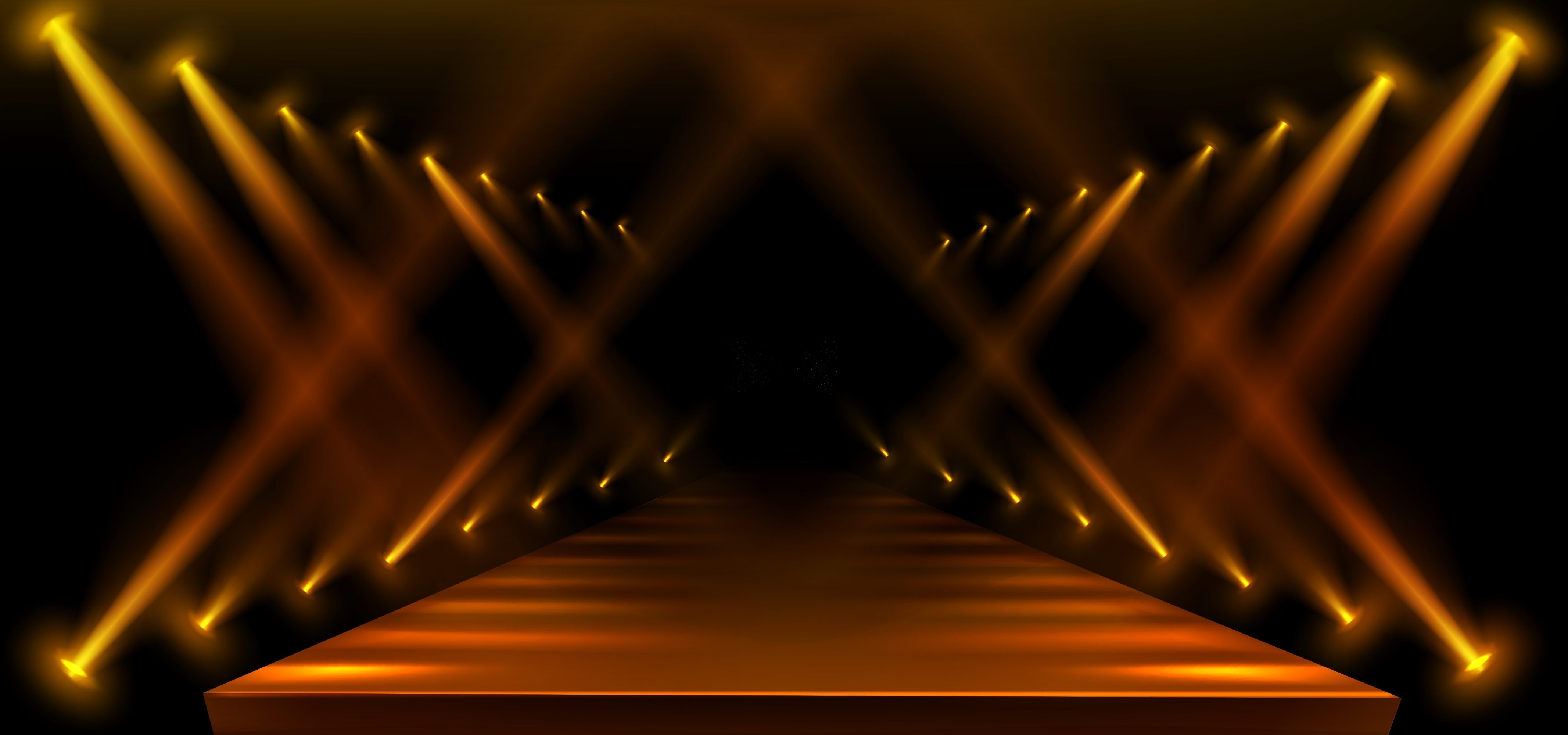 Empty fashion runway lit by golden spotlights
