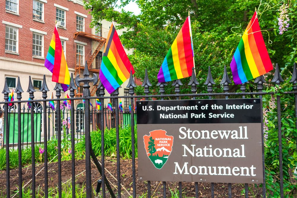 Brown sign with white lettering reading "Stonewall National Monument"