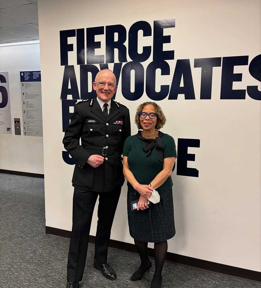 Commissioner Rowley and President Mason pose for a photo in front of the Fierce Advocates for Justice Sign