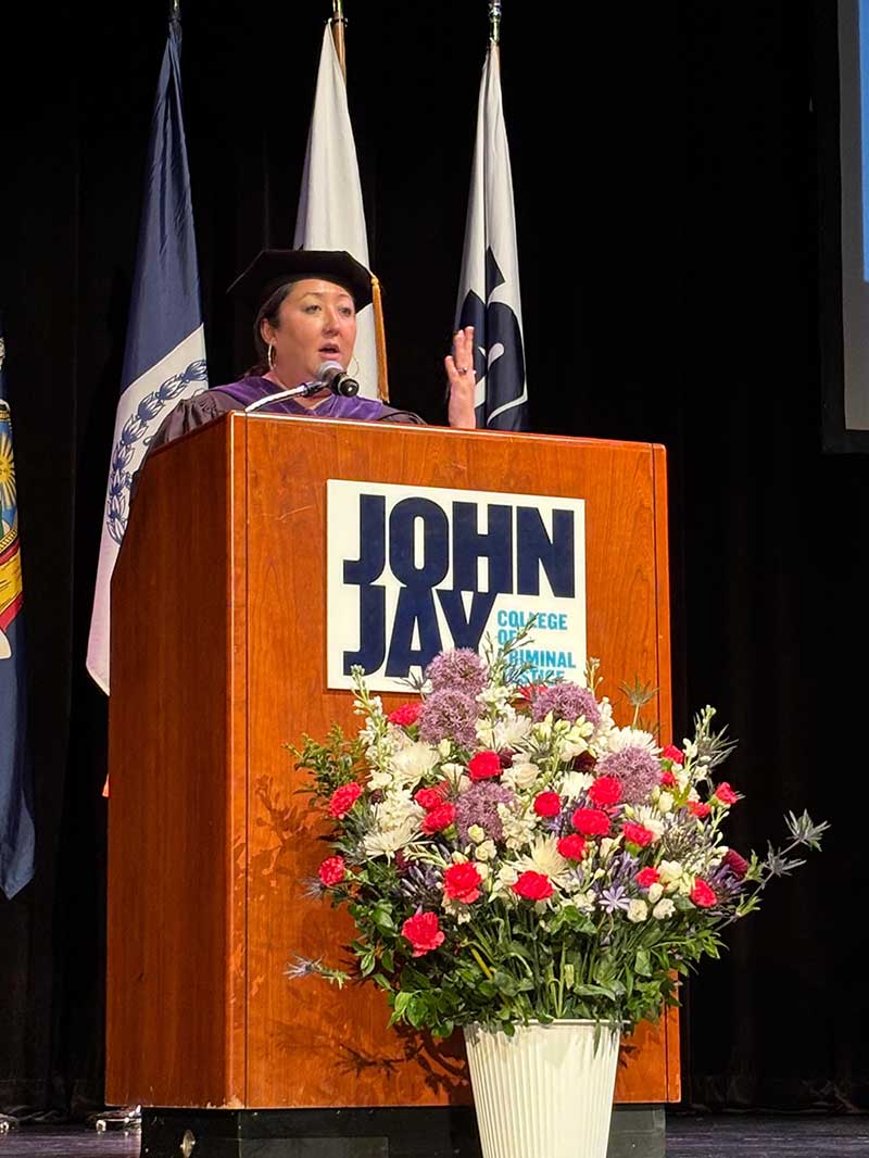 Commissioner Clarke speaking at hooding ceremony