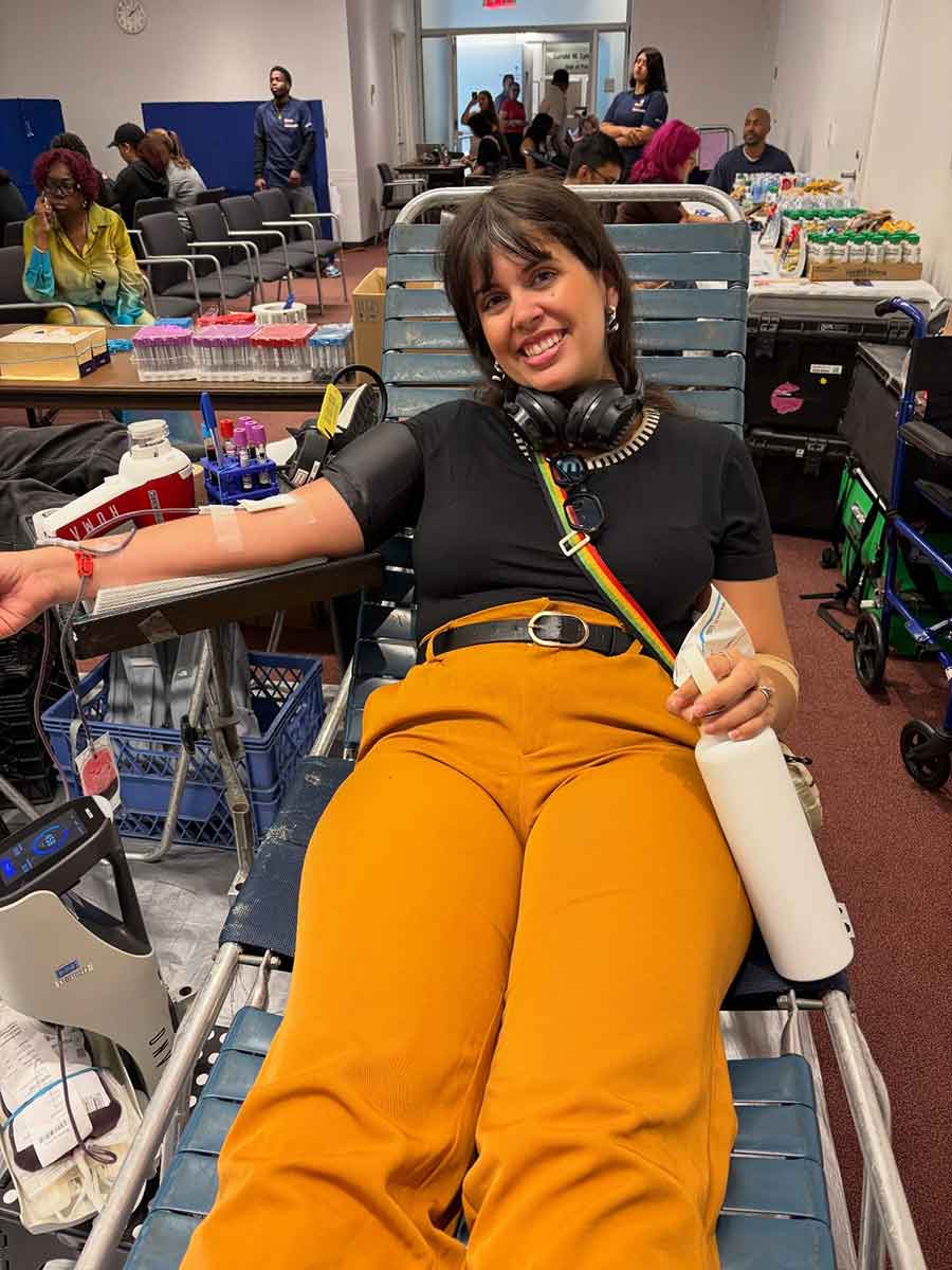 woman donating blood at blood drive