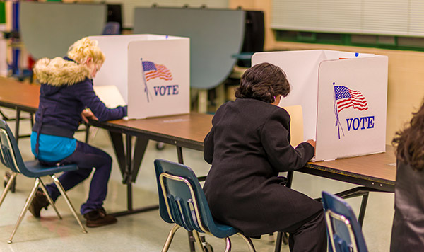 People in voting booths