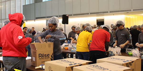 Students boxing up meals in partnership with Rise Against Hunger