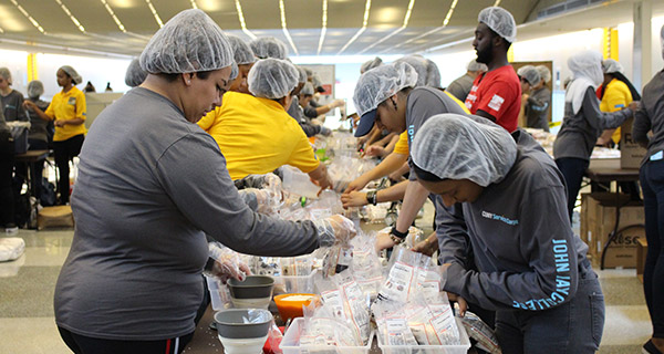 Students fills bags with rice