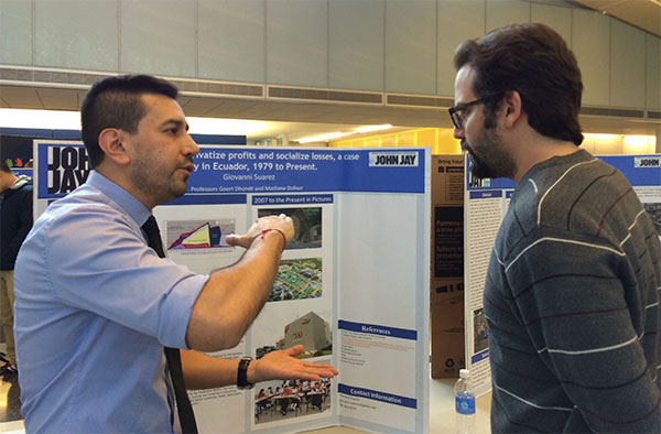 (left to right) Student Giovanni Suarez discussing his research, on how Neoliberalism privatizes profits and socializes losses in Ecuador, with Professor Ian Seda-Irizarry.