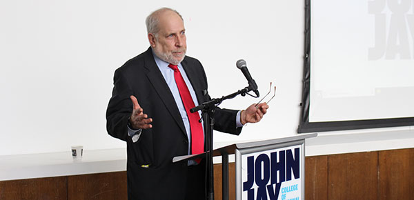 Stephen Handelman addresses attendees and those watching the symposium via livestream.