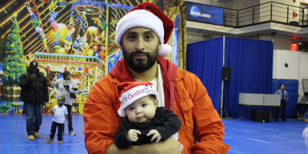 A father and child at the John Jay Annual Children's Holiday Party