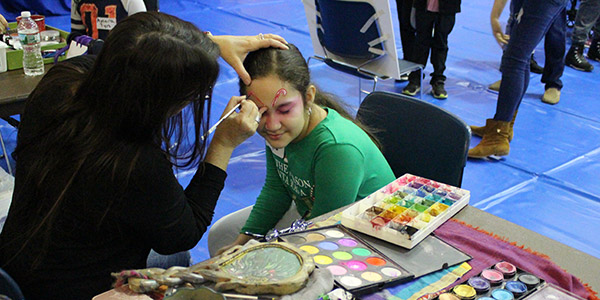 Facepainting at the John Jay Annual Children's Holiday Party