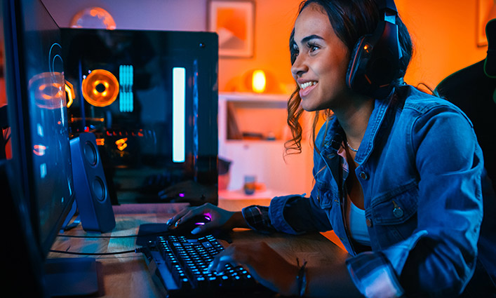 Young girl sitting playing games on a computer
