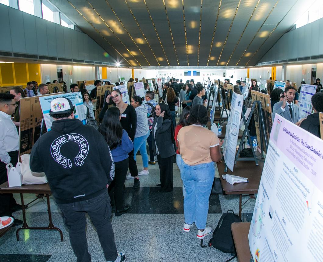 students gathered around research presentation boards