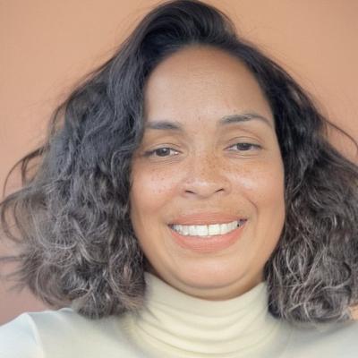Sharon Gandarilla-Javier smiling and wearing a white top