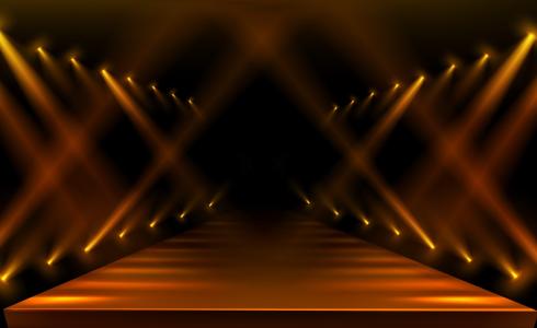 Empty fashion runway lit by golden spotlights