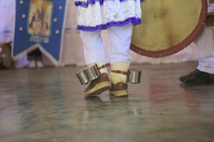 A dancer with instruments around their ankles