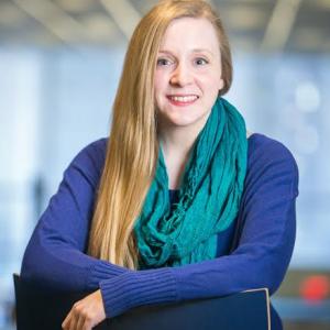 Smiling woman sitting backwards on a chair